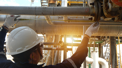 Engineer working on pipes at chemical plant